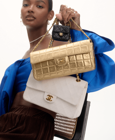 A model showing multiple different handbags together while wearing some jewelry
